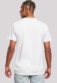 White cotton t-shirt with short sleeves and a crew neckline, featuring a smooth texture and a plain design, viewed from the back.