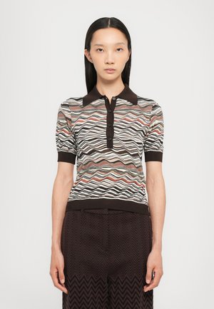 Knit polo shirt with a wave pattern in muted colors, brown collar, and five-button placket. Worn with dark patterned trousers.
