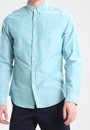 Lichtblauwe button-up shirt van zachte katoenstof, met een borstzak, ronde zoom en lange mouwen met knoopmanchetten.