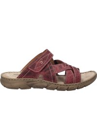 Red leather slide sandal with crossed straps and beige cushioned footbed. Durable rubber sole with textured grip for comfort and stability.