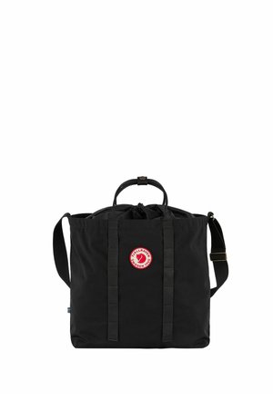 Black Fjallraven tote bag with top handles, adjustable shoulder strap, and circular red and white logo on front center.