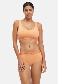 Oranges Sport-BH- und hochgeschnittenes Höschen-Set aus weichem Stoff, mit dem Markennamen "FALKE" auf dem Bund.
