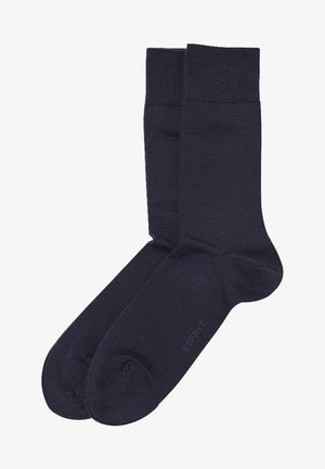 Marineblaue Socken aus einem glatten, strukturierten Material. Mit einem gerippten Bund und verstärktem Zeh, mit einem Logo, das nah am Zeh aufgedruckt ist.