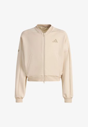 Beige cropped sweatshirt van zachte stof, met een rits aan de voorkant, twee zakken en een subtiel logo met drie strepen op de borst.