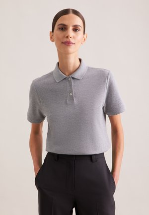Gray polo shirt with a classic collar and short sleeves, featuring a textured fabric and three-button placket. Worn with dark trousers.