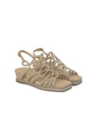 Sandales compensées beiges avec un design découpé complexe et des accents scintillants. Texture en daim doux et bride de cheville ajustable pour un maintien sécurisé.