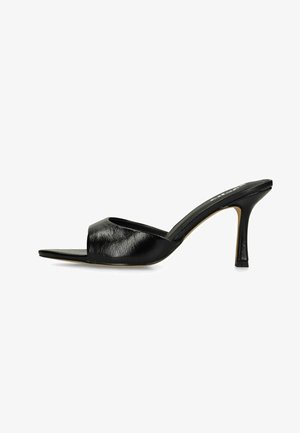 Black open-toe mule with a mid-height thin heel and a single wide leather strap across the foot.