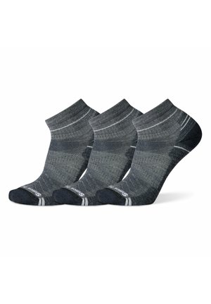 Drei Paar Knöchelsocken in Grautönen. Die Merkmale umfassen eine gerippte Textur, verstärkte Ferse und weiße Streifen am Bund.