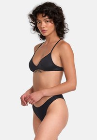 Black bikini set featuring a triangular top with thin straps and moderate coverage bottom, made from smooth, stretch fabric with a solid color.