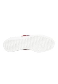 Sole di scarpa in gomma bianca con motivo di grip testurizzato, caratterizzata da un dettaglio circolare. I bordi sono arrotondati, con una finitura pulita e senza marchi visibili.