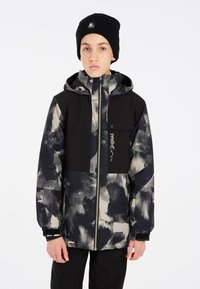 Schwarz-beige gemusterte Jacke mit Reißverschluss und Kapuze, ausgestattet mit einer Brusttasche, langen Ärmeln und verstellbaren Manschetten. Schwarze Mütze.