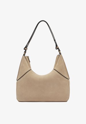 Beige suede handbag with a curved shape, black leather shoulder strap, and angular accents. Features minimal hardware and soft texture.