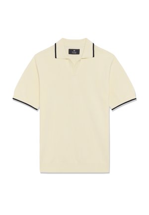 Kreemjas lühikeste varrukatega polo-särk musta äärisega krae ja varruka servadel, millel on väike lõhike krae all.