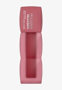 Maybelline Superstay Teddy Tint, design cilindrico, finitura rosa opaca, testo argentato metallico, dimensioni compatte con bordi arrotondati.