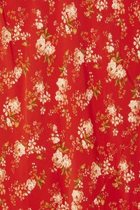 Red fabric featuring a floral pattern with pale pink and white flowers, green leaves, and a textured surface.