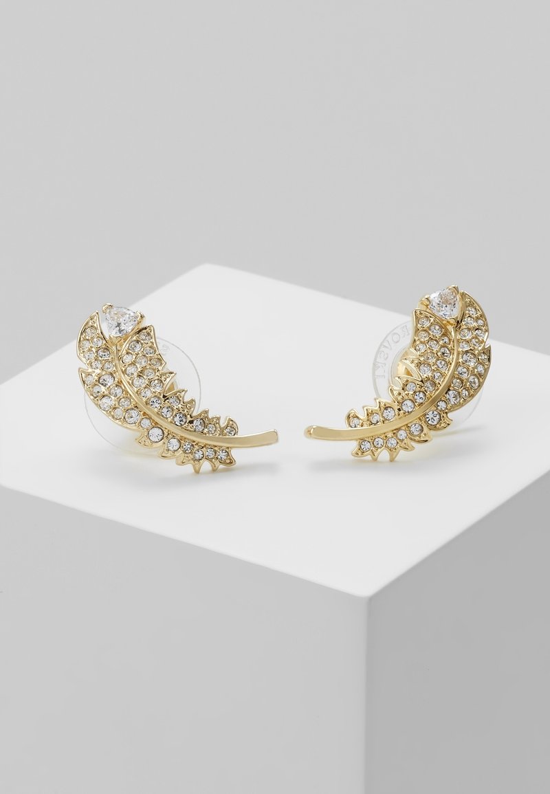 Paire de boucles d'oreilles dorées en forme de feuilles courbées, chacune ornée de multiples strass transparents pour scintiller.