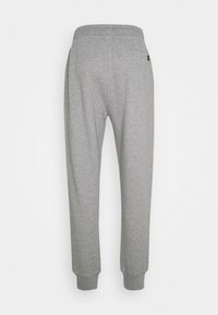 Graue Sweatpants mit einer weichen Textur, elastischem Bund und Bündchen an den Knöcheln. Verfügen über eine Gesäßtasche und ein einfaches Design.