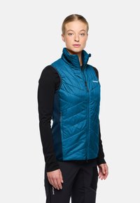 Türkisfarbener, ärmelloser, isolierter Weste mit Stehkragen und Zickzack-gestepptem Muster. Verfügt über einen Reißverschluss auf der Vorderseite und seitliche Taschen.