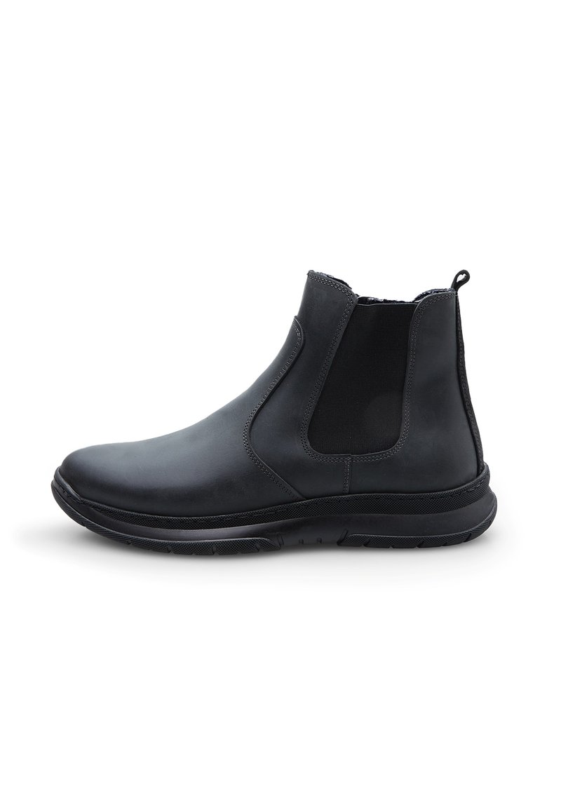 Botín Chelsea negro de cuero con paneles laterales elásticos, un cuello texturizado y una suela de goma para mayor tracción. Diseño elegante y aerodinámico.