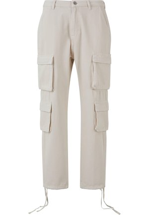 Beige cargo pants made of cotton, featuring four large pockets, a straight leg design, and adjustable ties at the ankles.