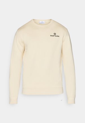 Cream sweatshirt with long sleeves, ribbed cuffs, and hem. Features a black logo on the upper left chest. Soft texture, minimalistic design.