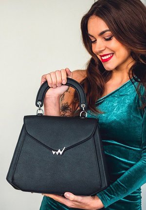 Schwarze Handtasche aus Kunstleder mit strukturiertem Design, silbernem Zubehör und einem markanten Logo. Verfügt über einen oberen Griff für praktisches Tragen.