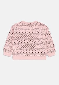 Rosa sweatshirt med svart prikk- og linjemønster. Har en rund hals og ribbede mansjetter og midjebånd. Myk stoffstruktur.