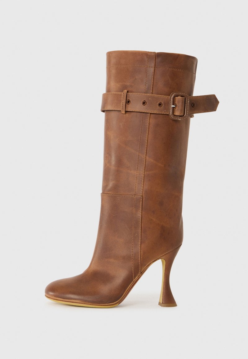 Brown leather high-heeled boot with a fitted design, a wide cuff, and a belted accent around the ankle. Smooth texture and pointed toe.