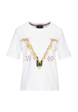White cotton T-shirt featuring a large pink "V" with gold chain and black accents, and the year "1969" in purple underneath. Short sleeves.