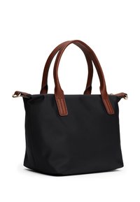 Black fabric tote bag with brown leather handles. Square shape with minimal design, featuring stitching details and a small gold hardware accent.