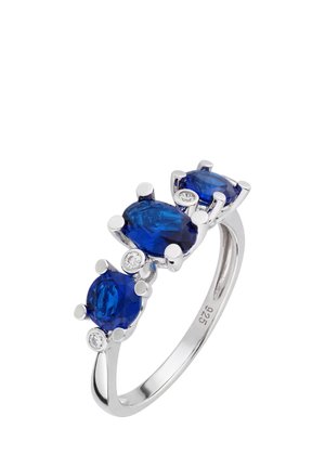 Silver ring with three blue oval and round gemstones, accented by small clear stones, band marked with "925" for sterling silver.