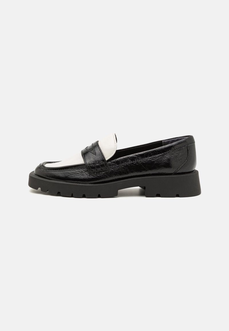 Black and white leather loafers with a textured upper, rounded toe, and chunky black rubber sole featuring a tread pattern.