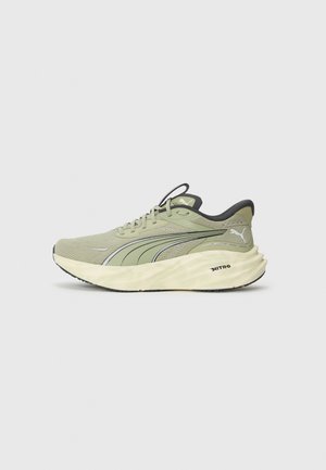 Light green running shoes with textured mesh upper, reflective accents, thick cushioned sole, and black detailing on the heel and outsole.