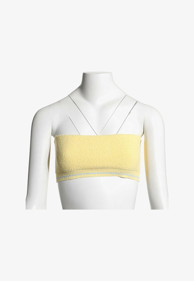 Haut bandeau texturé jaune sur mannequin blanc sans tête avec fines bretelles noires croisées à l’avant.