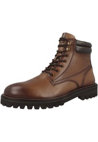 Bottine en cuir marron avec fermeture à lacets, bout arrondi et accents marron foncé contrastants autour du col. Semelle épaisse et robuste.