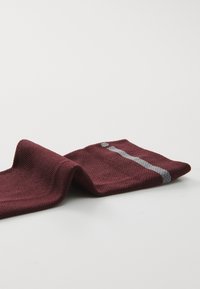 Calcetín de punto burdeos con una superficie texturizada, que presenta un diseño de rayas grises. El calcetín está parcialmente doblado para mostrar su forma y color.