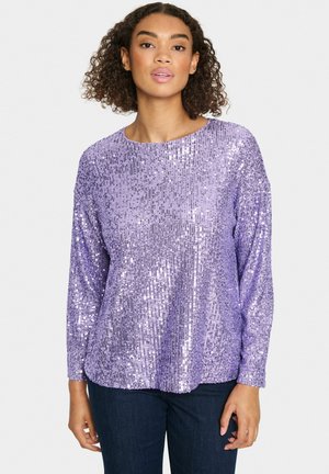 Purple sequin top with long sleeves and a round neckline, featuring a textured surface of shimmering sequins in a vertical pattern.