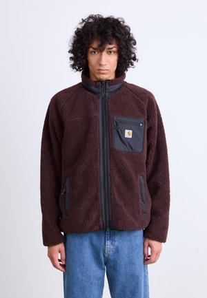 Brown fleece jacket with black zippered pockets, high collar, and textured surface. Features a logo patch on the left chest.