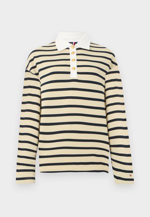 Beige overhemd met lange mouwen, zwarte horizontale strepen, witte kraag, vier gouden knopen en een klein logo op de linkermouwmanchet.