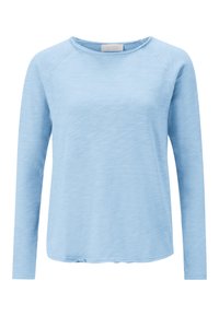 Camicia azzurra chiara a maniche lunghe con scollo arrotondato, maniche raglan e vestibilità rilassata. Il tessuto ha un aspetto morbido e leggermente strutturato.