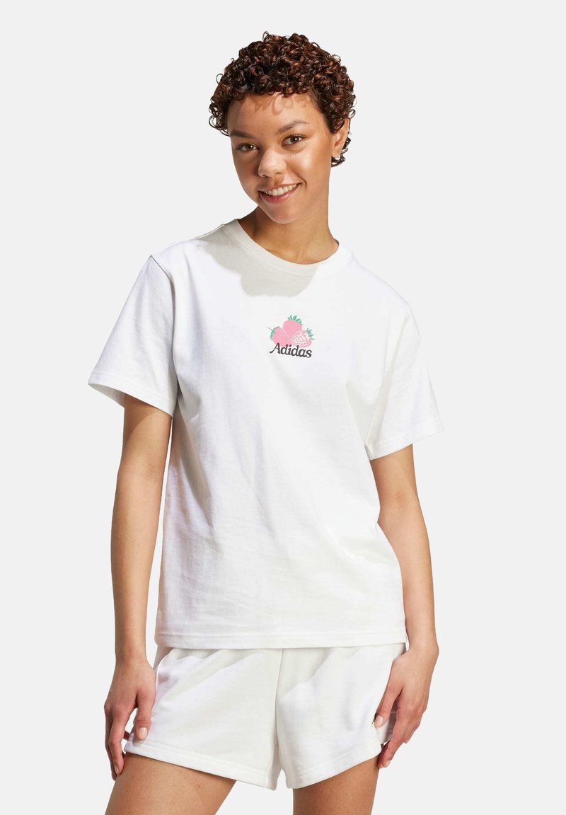 Vit bomull t-shirt med rund hals och korta ärmar, med en rosa ananas och "Adidas"-logotyp i grönt.