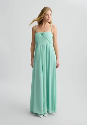 Abito maxi verde menta con scollatura a nodo, spalline sottili e gonna fluida realizzata in tessuto leggero. Presenta un design semplice.