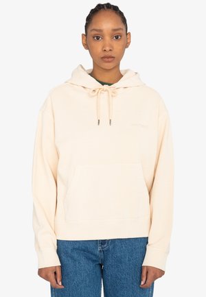 Haut à capuche crème avec un cordon de serrage, poche avant, poignets côtelés et logo "element" notable sur la poitrine. Porté avec un jean bleu.