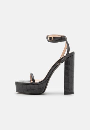 RAID ELIXEN - Magas sarkú szandálok - black