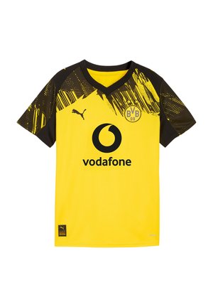 Żółta i czarna koszulka piłkarska Borussii Dortmund z logo Vodafone, logo Puma i herbem BVB 09 na piersi oraz z wzorzystymi rękawami.