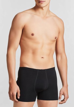 Boxer shorts neri in cotone con un design aderente e cuciture a contrasto. La vita è elasticizzata per garantire comfort e supporto.