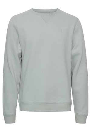 Sweat-shirt gris clair avec encolure ras du cou, poignets et ourlet côtelés. Présente un logo discret sur la poitrine et une texture lisse et douce.