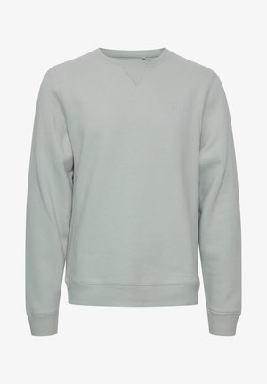 Jasnoszary sweatshirt z okrągłym dekoltem, ściągaczami przy rękawach i u dołu. Posiada subtelne logo na piersi oraz gładką, miękką fakturę.
