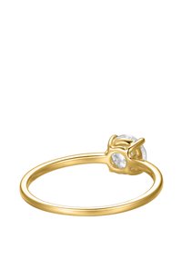 Gold ring featuring a round clear gemstone set in a four-prong mounting, with a smooth, slender band. The design is minimalistic and elegant.