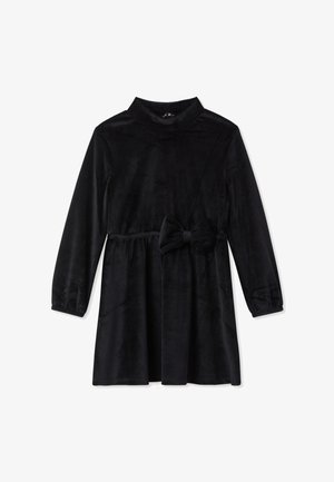 Abito in corduroy nero con maniche lunghe, collo alto e vita arricciata. Accentuato da un grande fiocco in vita.